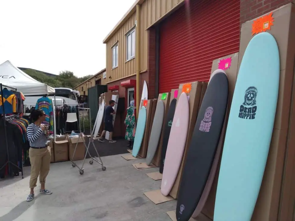 surfboards lined up at a shop