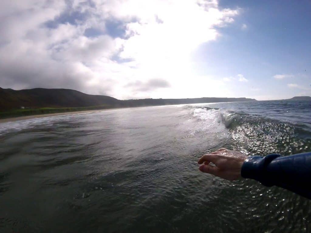 surfer's hand while riding a wave