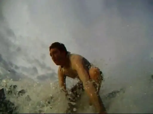 surfer standing up on a board