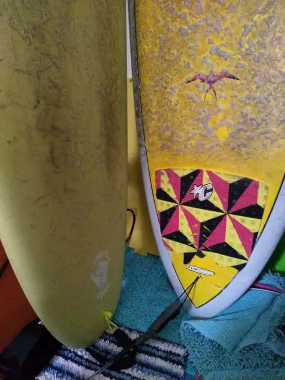 2 surfboards - one with a tailpad, the other without