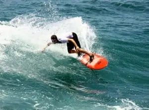 the author doing a cutback at Uluwatu in Bali on ared epoxy santa cruz surfboard