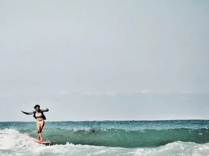 lady surfer riding a wave