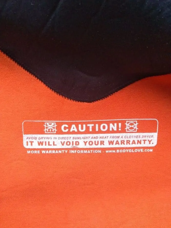 label inside a wetsuit warning not to spin dry it