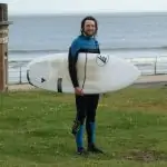 surfer with blue Oneill chest zip wetsuit