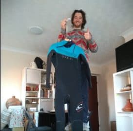 me weighing my winter surf wetsuit when dry