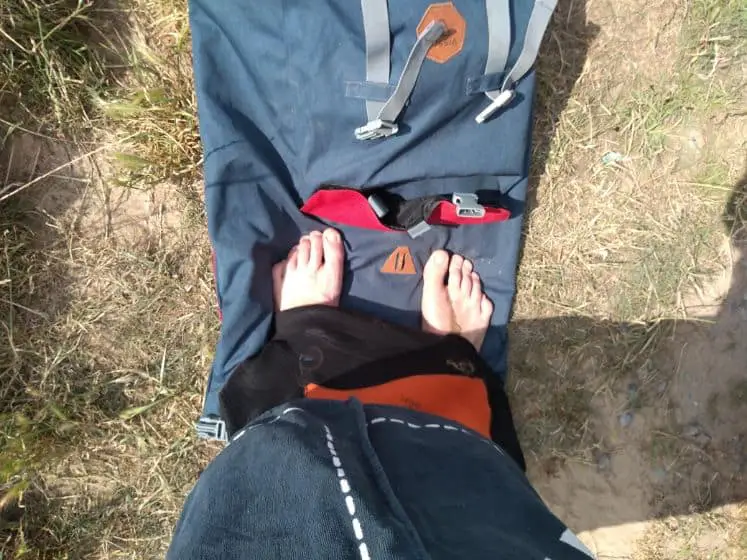standing on wetsuit bag for changing